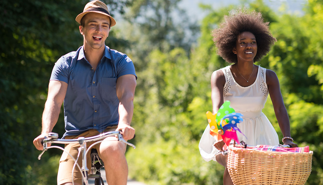 Man and woman on bikes in the summer
